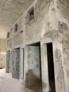 Voile en parpaings pleins avec poteaux et chaînages coffrées et coulés en place, réservations sur mesure