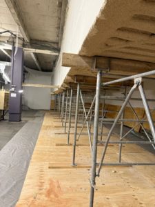 BATI-IDF rangée d'étais provisoires en place sous la coursive, surmontés de bastaings — étaiement avant désolidarisation. Centre de tri La Poste, Paris 17e.