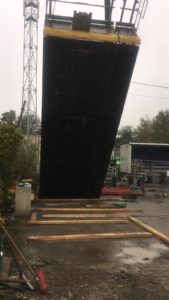 BATI-IDF levage à la grue d'une banche à matrice pour le coffrage des voiles en béton architectonique — passerelle de la gare d'Us (95)